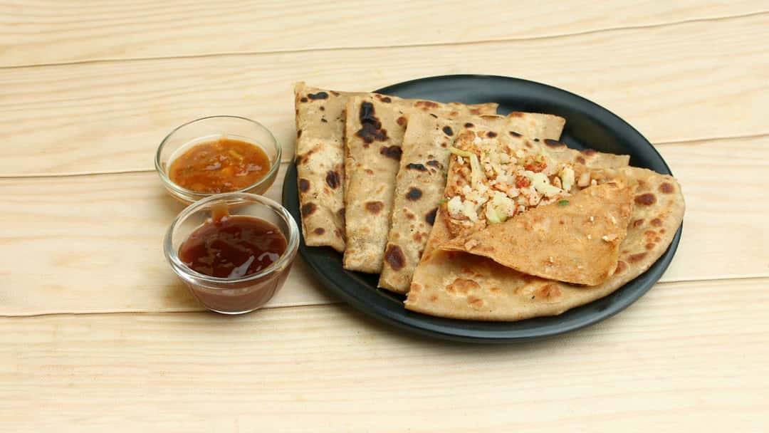 Gobi masala stuffed paratha on a plate. (banner image)
