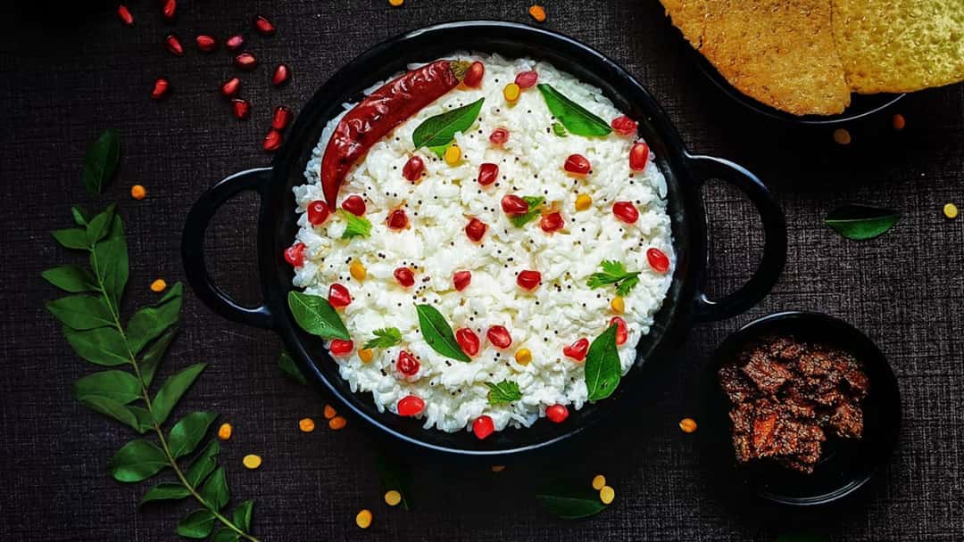 Curd rice in a black ceramic bowl