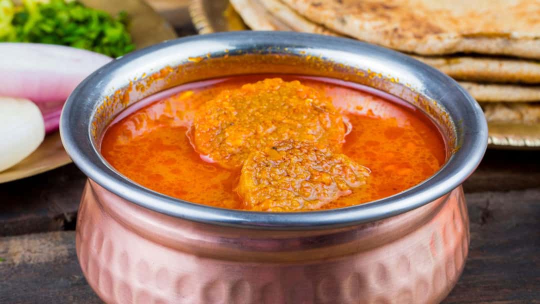Gatte ki sabzi in a small brass bowl