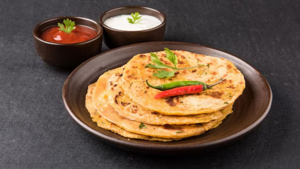 Stack of Indian parathas with dips
